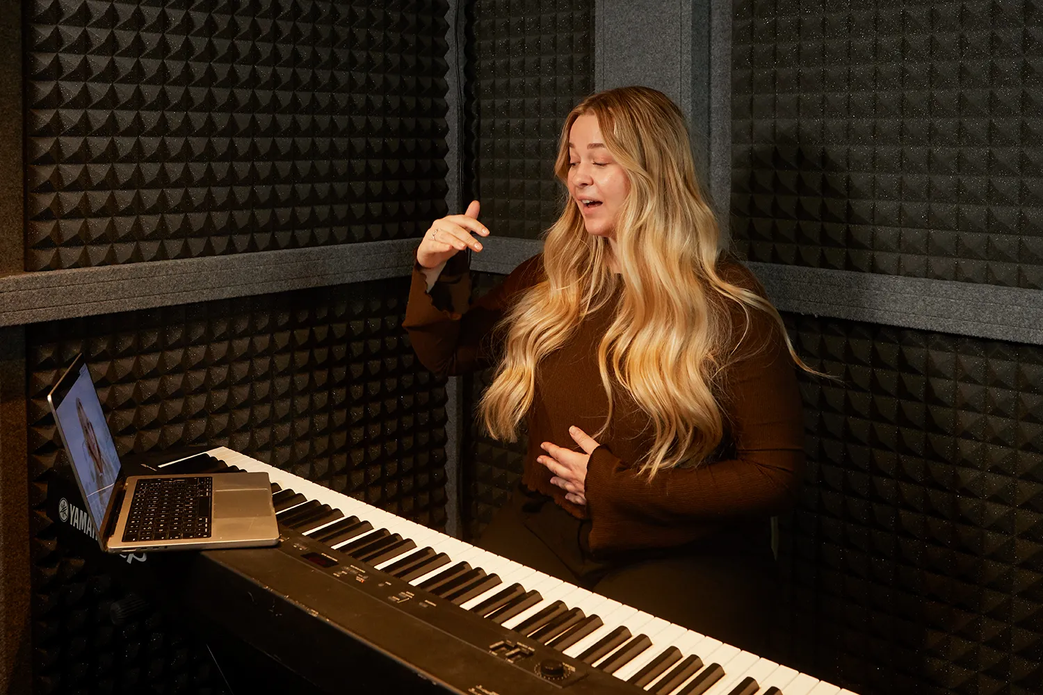 person singing at keyboard