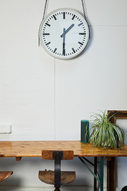 clock on wall, plant on desk at singing school