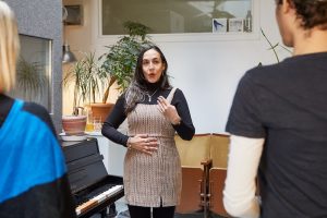 singing teacher conducting vocal warm ups