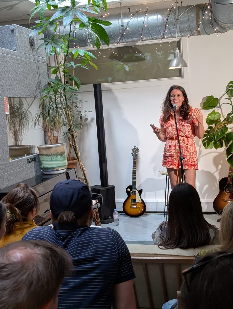female singer on stage at an open mic night