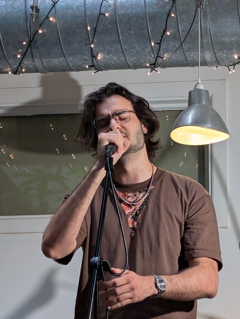 Man singing into a Microphone at an open mic night