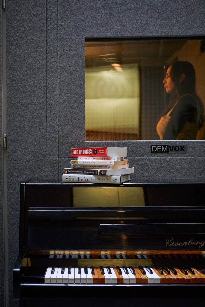 City Vocal Coach teacher singing in a vocal booth