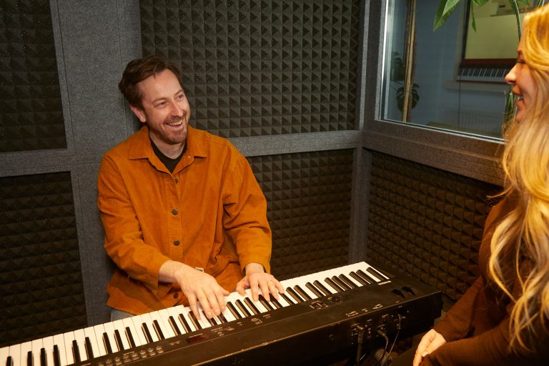 Singing teacher smiling at student